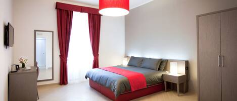 Triple Room | Minibar, in-room safe, individually decorated, desk