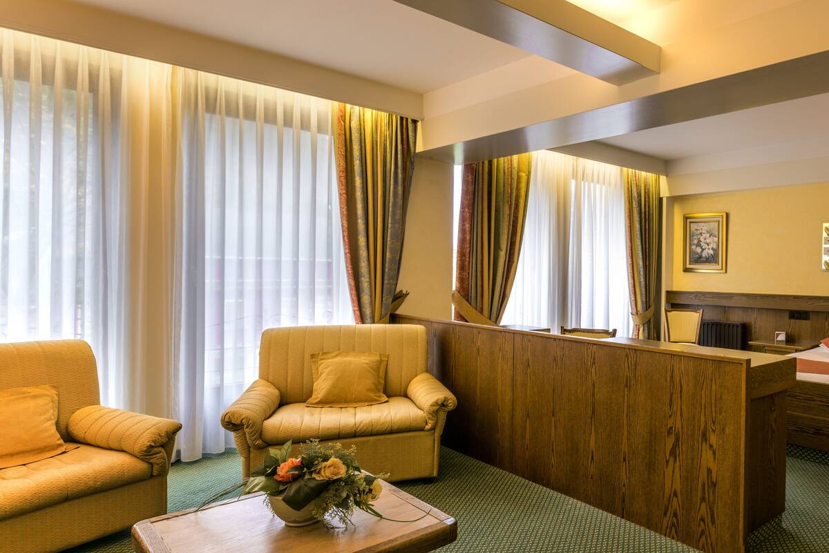 Deluxe Suite, River View | Premium bedding, minibar, in-room safe, desk