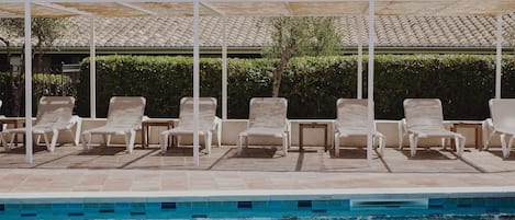 Outdoor pool, open 8 AM to 8 PM, pool umbrellas, pool loungers