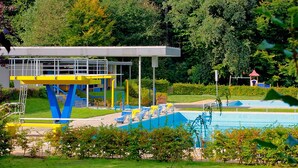 A swimming pool with a diving platform and changing rooms. - Landhaus Sundern (Tecklenburg)