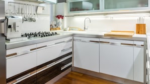 A modern kitchen with white cabinetry, a built-in stove, and a wooden countertop. - UNIQUE & URBAN 4* House DelMarco apt @ TOP CENTRAL LOCATION (Split)