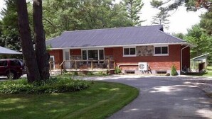 A two-story house with a front porch, a garage, and a driveway.