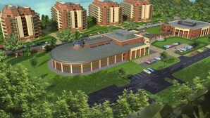 A residential complex with multiple high-rise buildings, a central circular building, and a view of the sea. - Galerius Panorama Beach - D Apartman (Siófok)