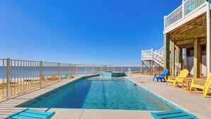 A pool with a view of the beach, deck chairs, and a wooden deck. - Ocean Springs 'Magnolia Beach House' on Pvt Beach! (Ocean Springs)