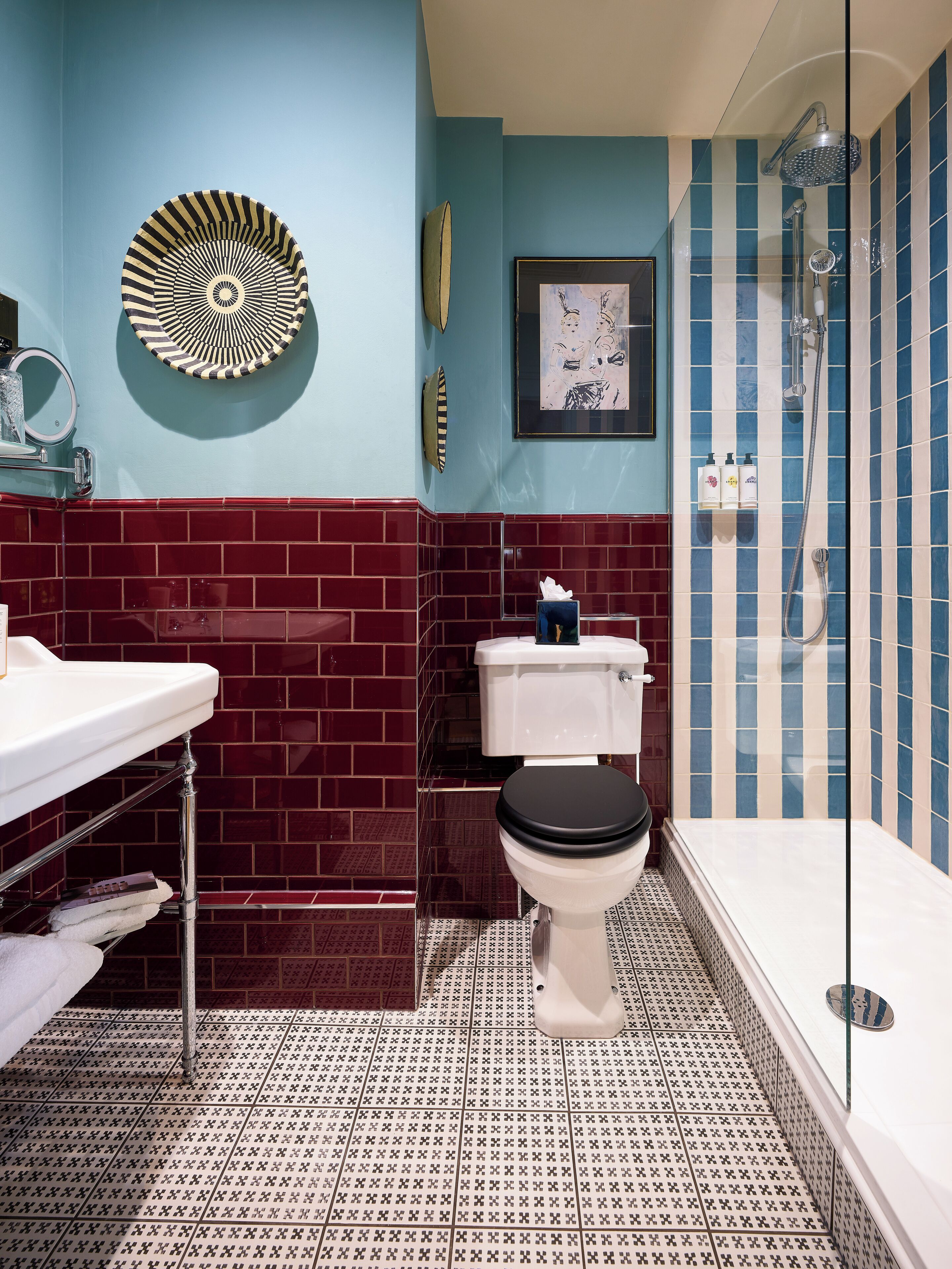 A bathroom with a toilet, sink, and shower.