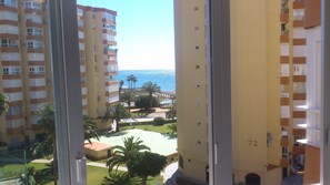 A high-rise building with balconies overlooking a pool area and the sea. - APARTMENT STUDIO IN FRONTLINE BEACH, SEA VIEWS, POOL, TENNIS (Algarrobo)