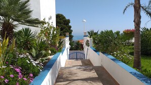 A pathway leading to a gate with a view of the sea. - SPAIN, PENISCOLA, apartment for rent in beautiful residence (Peniscola)