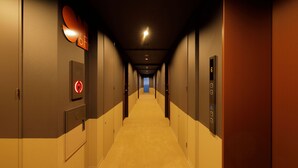 A hotel hallway with a carpeted floor, a fire alarm on the left, and an elevator control panel on the right. - Smart Place Inn Kyoto Shijo Omiya East (Kyoto)