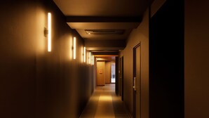 A long, narrow hotel corridor with a tiled floor and walls lined with doors. - Smart Place Inn Kyoto Shijo Omiya East (Kyoto)