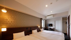 A hotel room with a large bed, a desk with a chair, a television, and an air conditioning unit. - Smart Place Inn Kyoto Shijo Omiya East (Kyoto)
