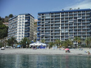 Guests can enjoy stunning ocean views from the hotel's spacious balconies overlooking the pebble beach.