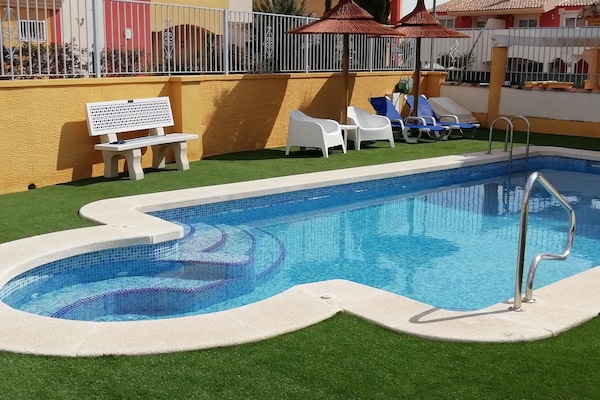Community pool with faux grass