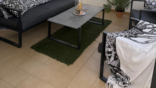 A covered outdoor seating area with a sofa, coffee table, and chairs, a potted plant, and a wall with a decorative sign. - Stylish Villa, community pool typical Spanish village in La Tercia, Murcia  (Murcia)