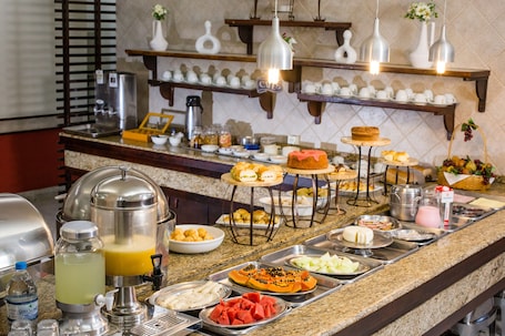 A buffet with various food items and beverages.