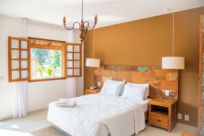 Cozy retreat with a large bed, nightstands, and a rustic headboard.