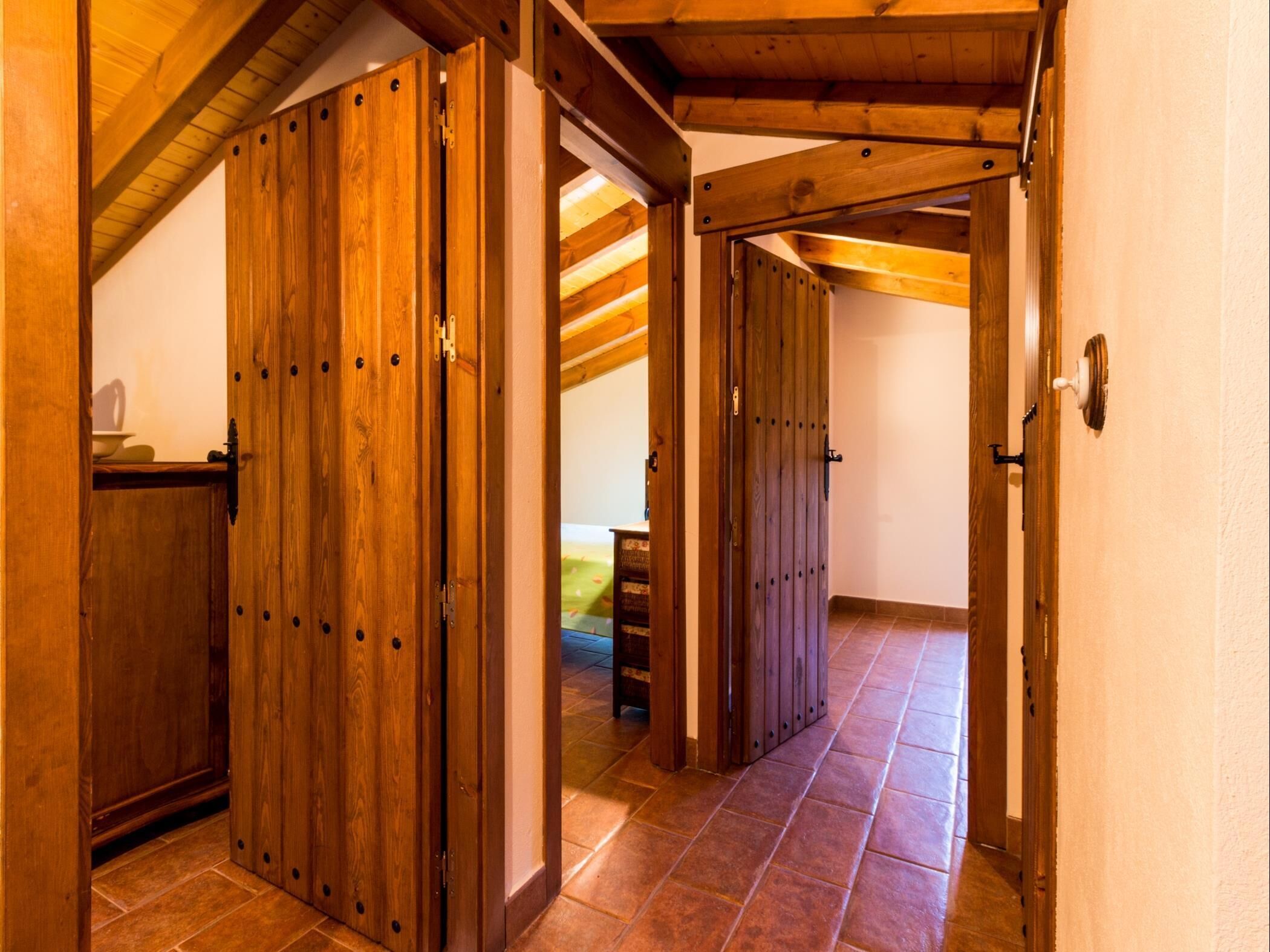A wooden interior with a high ceiling and a tiled floor.