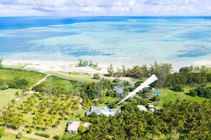 A tropical resort with a large pool, beachfront property, and lush greenery. - Villa La Cocoteraie, 400 sqm, close to the beach, in a beautiful garden (Baie du Cap)