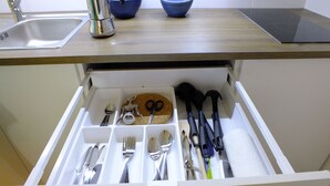 A kitchen drawer with utensils and a cake. - Santa Cruz Ocean Apartment - II (Santa Cruz)