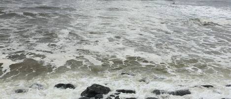 A rocky shoreline with turbulent waves.