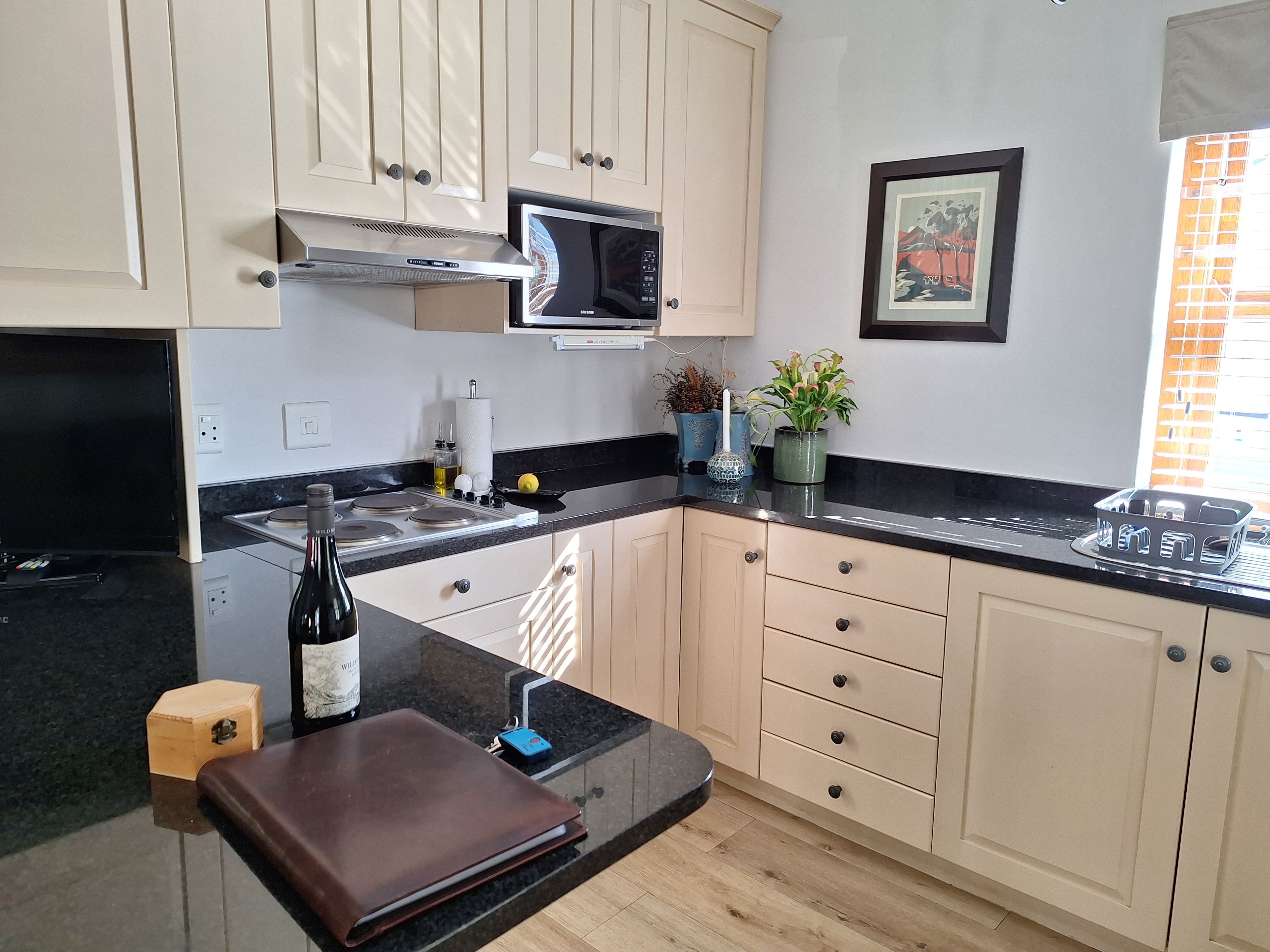 A modern kitchen with a microwave, stove, and cabinets.