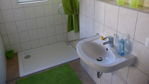A bathroom with a bathtub, a sink, and a window.