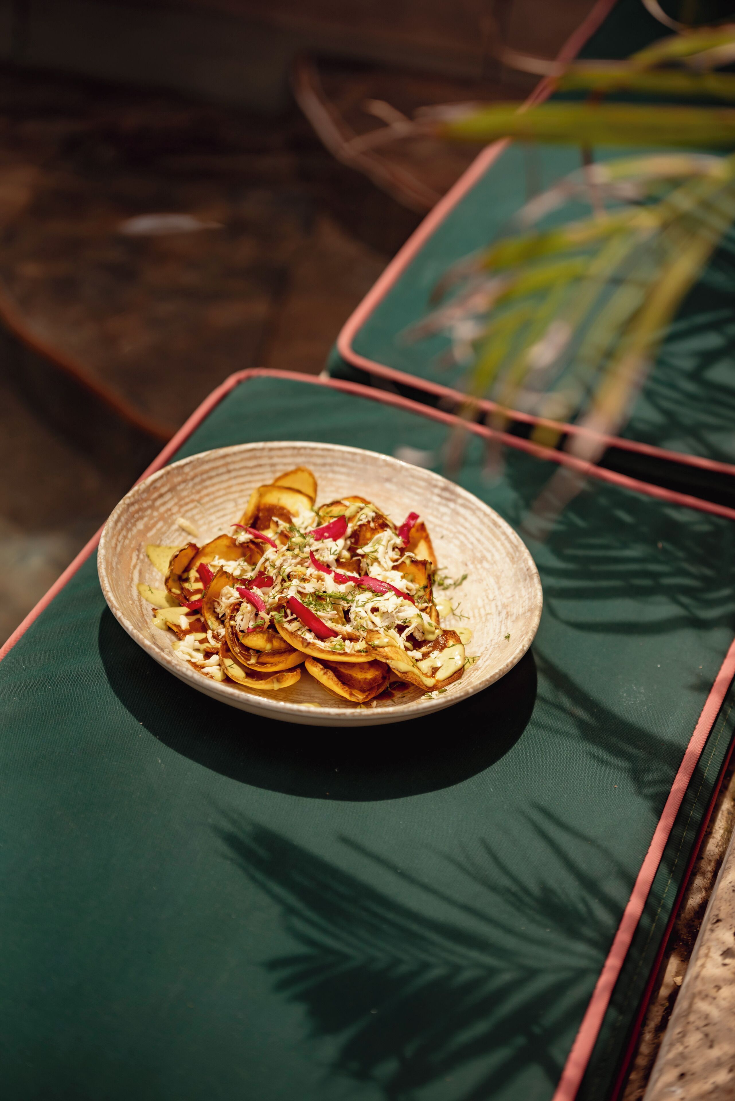 A plate of food on a green table with a red border.