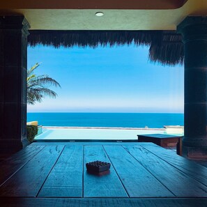 A wooden deck with a view of the ocean.
