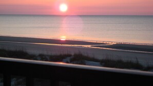A sunset over a beach with calm waters and a clear sky. - True DIRECT Oceanfront - Admiral's Row 305 - Right on the Beach!  Best View! (Hilton Head Island)