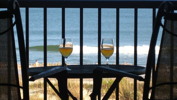 A wooden bench with two glasses of wine facing the ocean. - True DIRECT Oceanfront - Admiral's Row 305 - Right on the Beach!  Best View! (Hilton Head Island)