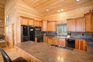 Enjoy cooking in this well-equipped kitchen with a refrigerator, microwave, and dishwasher.