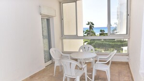A balcony with a table and chairs, a view of the sea, and a door. - B&B Cote d'azur, Your seaside holiday in Hammamet.<br> (Hammamet)