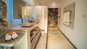 A modern bathroom with a large mirror, a stone shower, and a towel rack. - Exclusive Private 8 Bedroom Estate, 2 Huge Pools, Seminyak (Seminyak)