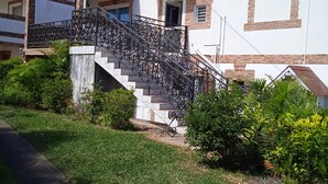 A two-story building with a staircase and a covered porch.