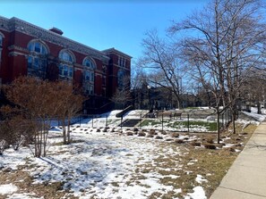 Stately historic building with arched windows and a well-manicured lawn.