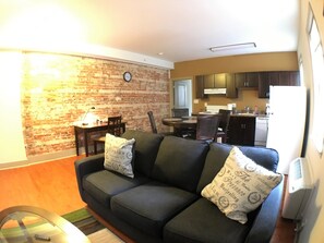Relax in this inviting living space with a sofa, dining area, and fully equipped kitchen.
