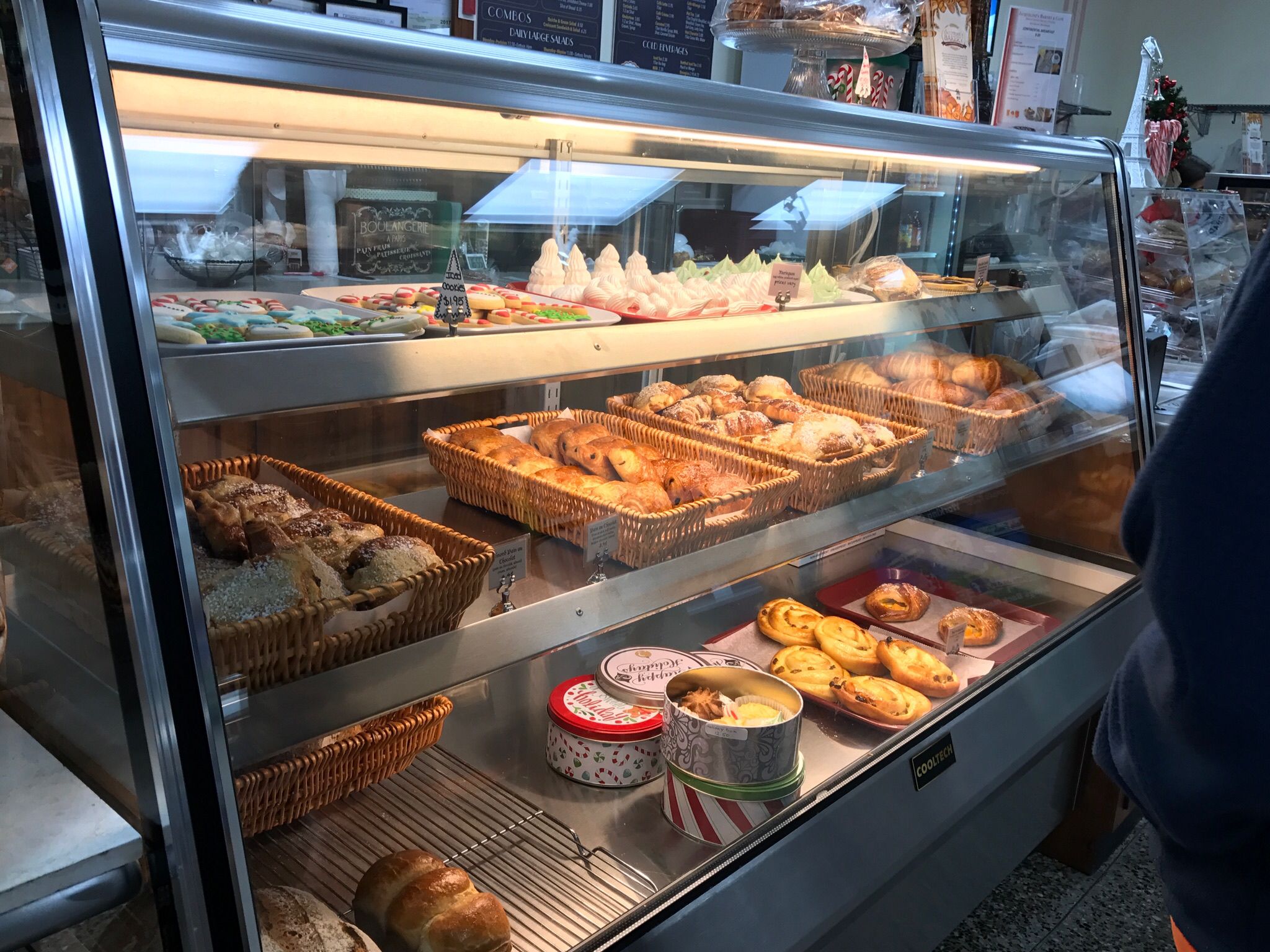 A bakery display case with various baked goods.