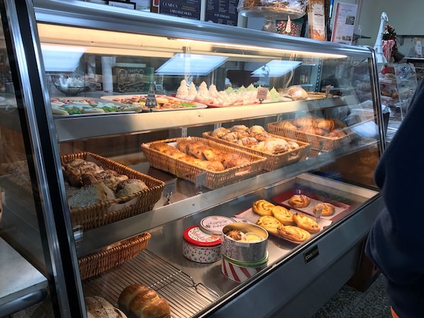 A bakery display case with various baked goods.