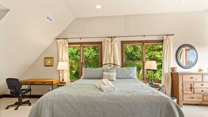A bedroom with a large bed, a desk, and a dresser. - Mountain Cabin On Quiet Property (Boone)