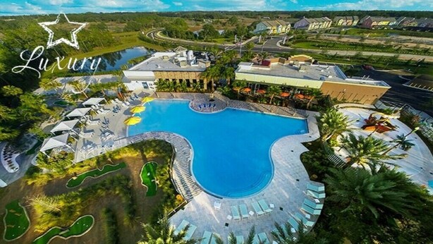 A luxury resort with a large swimming pool, sun loungers, and a golf course. - Festive Family Fun! Resort Close 2 Disney! Private Pool! 422 (Davenport)