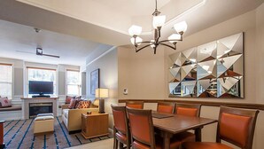 A hotel room with a dining area, a living room with a fireplace, and a large mirror on the wall. - Marriott Summit Watch Full 2 Bed/2 Bath sleeps 8 at the Town Lift on Main St. (Park City)