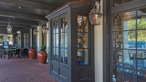 A covered outdoor area with brick flooring, large windows, and hanging lanterns. - PRIVATE BEACH/ POOL ACCESS- Meticulously Maintained- 4 Bikes Included (Rosemary Beach)