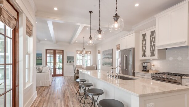 A spacious kitchen with a large island, bar stools, and modern appliances. - PRIVATE BEACH/ POOL ACCESS- Meticulously Maintained- 4 Bikes Included (Rosemary Beach)