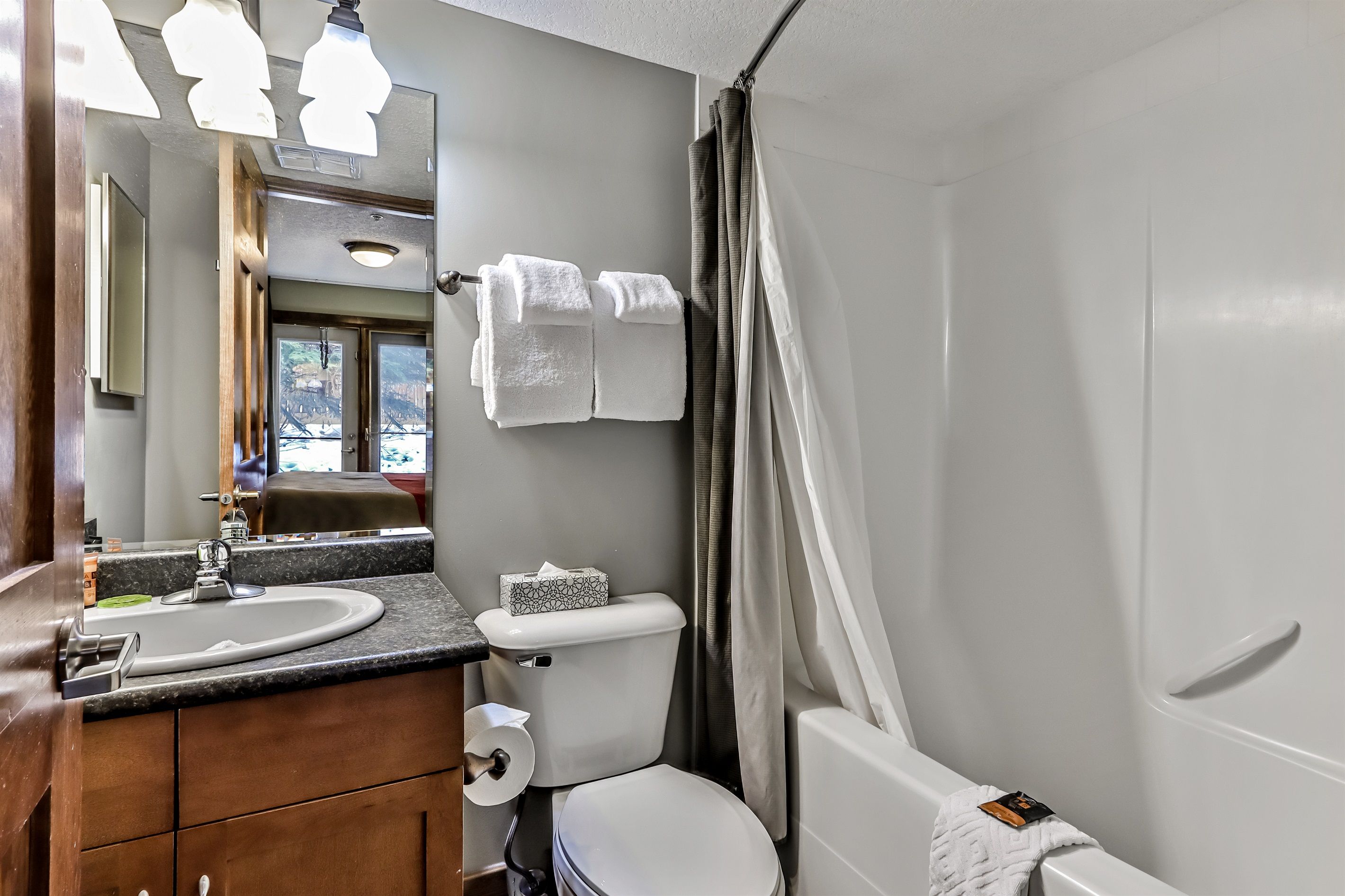 Une salle de bain équipée d’un lavabo, de toilettes et d’un rideau de douche.