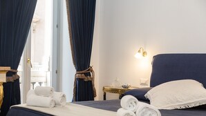 A hotel room with a bed, a nightstand, a lamp, and a view of the outside. - Amazing Suite Piazza Venezia Suite Int. 3 (Roma)