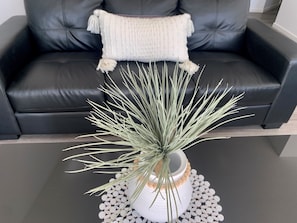 A potted plant with long, thin leaves on a table. - Broadbeach Getaway 510 (Broadbeach)