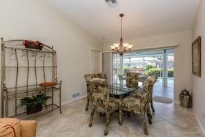 Enjoy meals in this stylish dining area with a glass-top table and comfortable seating for four.