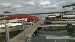 A marina with docked boats, a wooden dock, and a cloudy sky. - Gun Lake Cottage shared lake frontage, 7 Miles to Casino, Volleyball Playgrounds (Wayland)