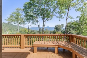 Expansive deck with built in seating overlooking the surrounding mountains