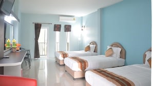 A hotel room with three beds, a desk with a television, and a window with curtains. - Satun Boutique Resort (Satun)