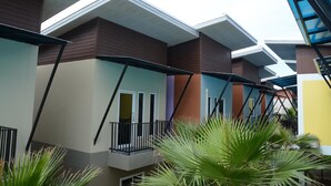 A multi-story residential building with a modern architectural design, featuring balconies and a flat roof. - Satun Boutique Resort (Satun)